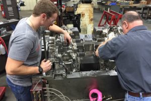 Two men working on Mold Adjustments